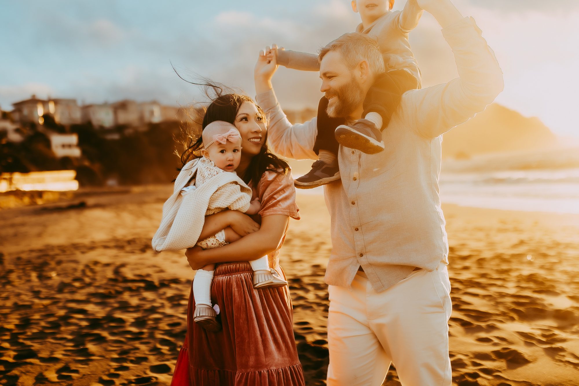 Shefali Parekh | Capturing Joy and Laughter: The Family Session at Baker Beach Couple looking at each other with their children