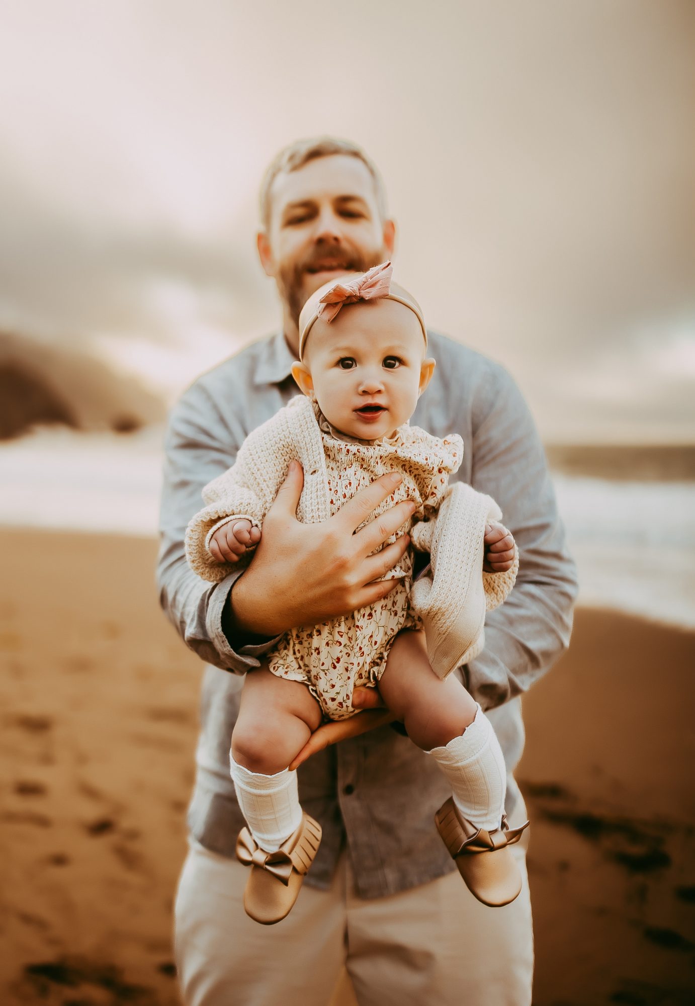 Shefali Parekh | Capturing Joy and Laughter: The Family Session at Baker Beach A father cherishing a precious moment with his baby on a beach