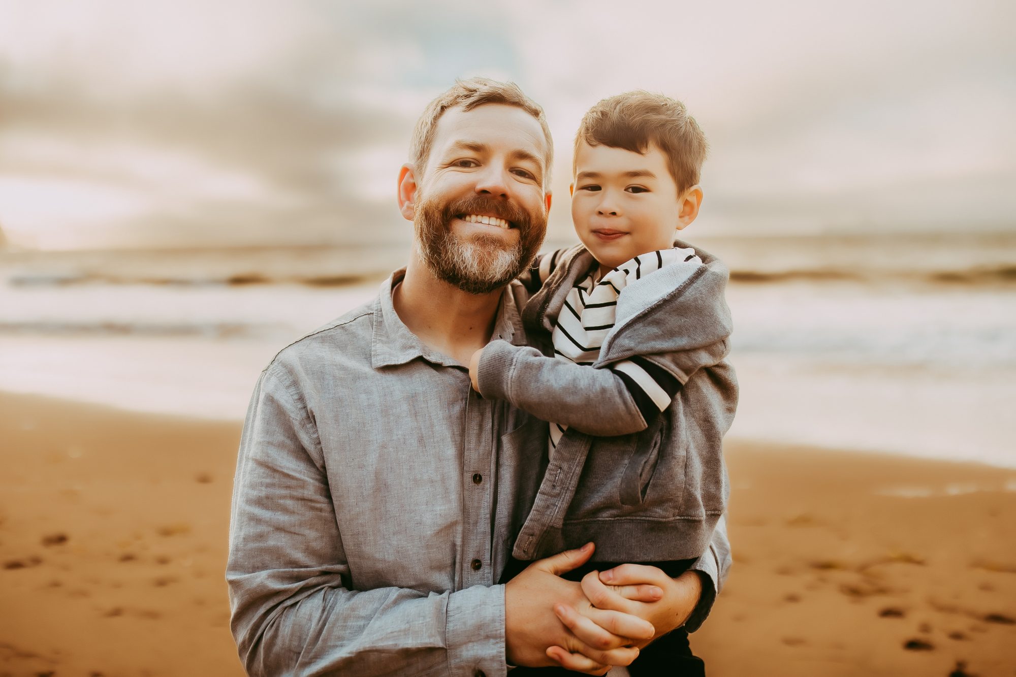 Shefali Parekh | Capturing Joy and Laughter: The Family Session at Baker Beach A father and his son standing on a beach at sunset