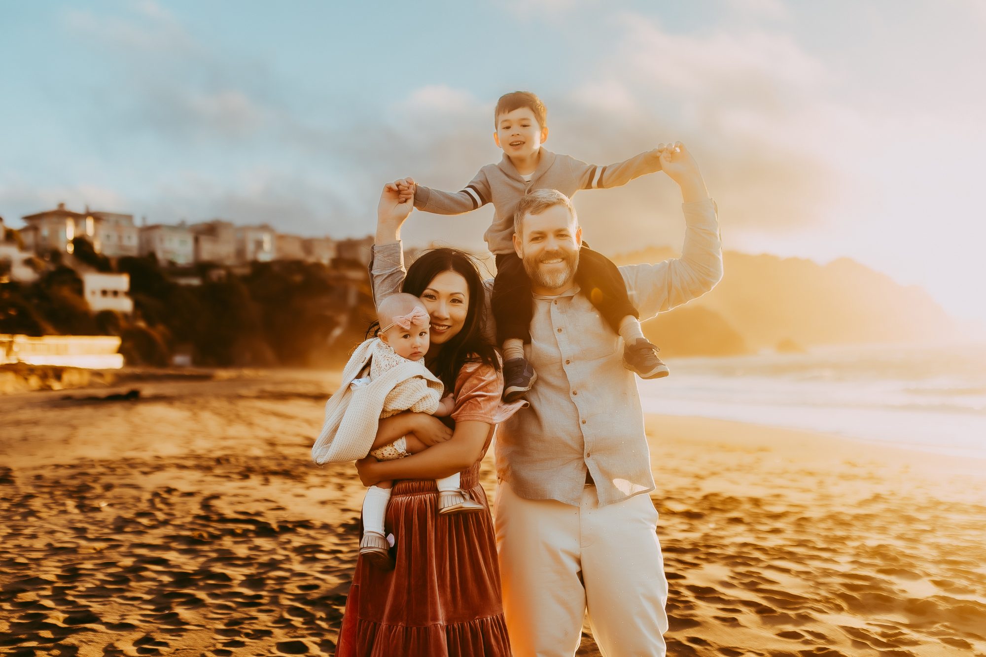 Shefali Parekh | Capturing Joy and Laughter: The Family Session at Baker Beach A stunning sunset over a serene ocean with a happy family