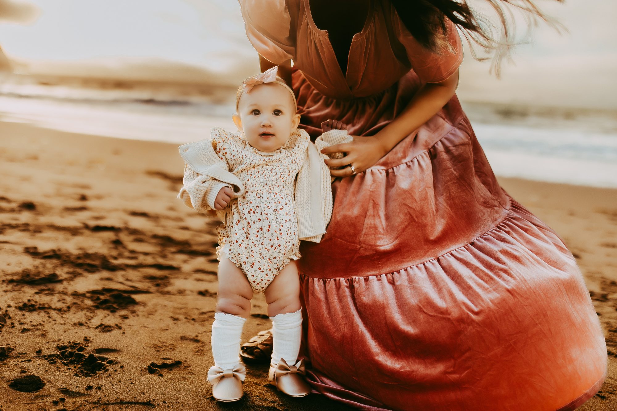 Shefali Parekh | Capturing Joy and Laughter: The Family Session at Baker Beach A mother holding her adorable baby