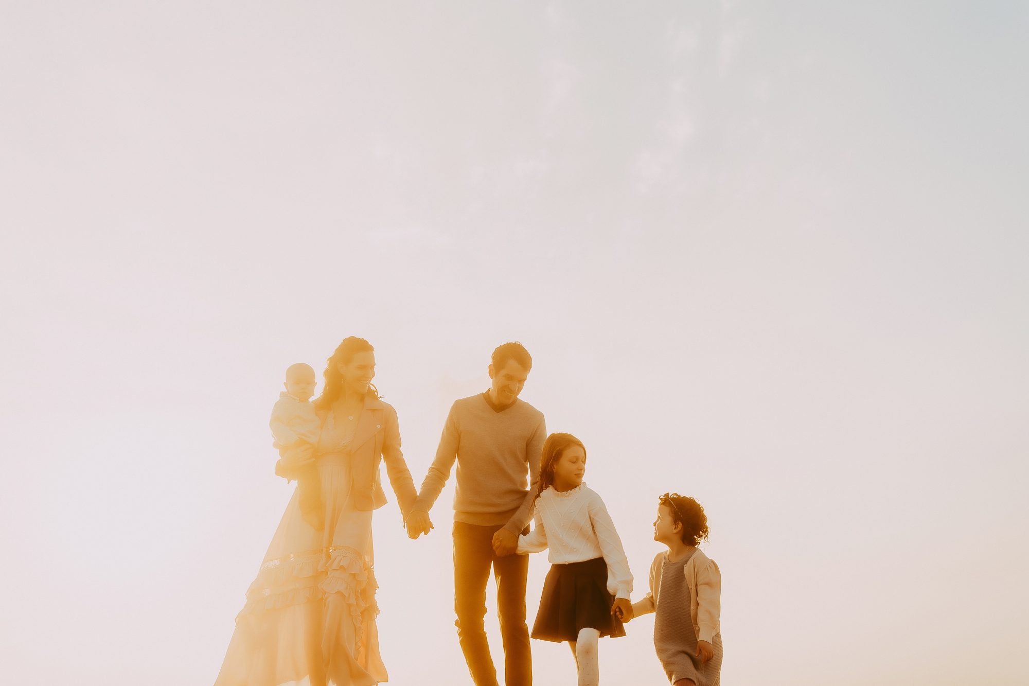 Shefali Parekh | Sunrise Family Photography in Marin County: Capturing Magic in the Morning Family of five posing hand in hand