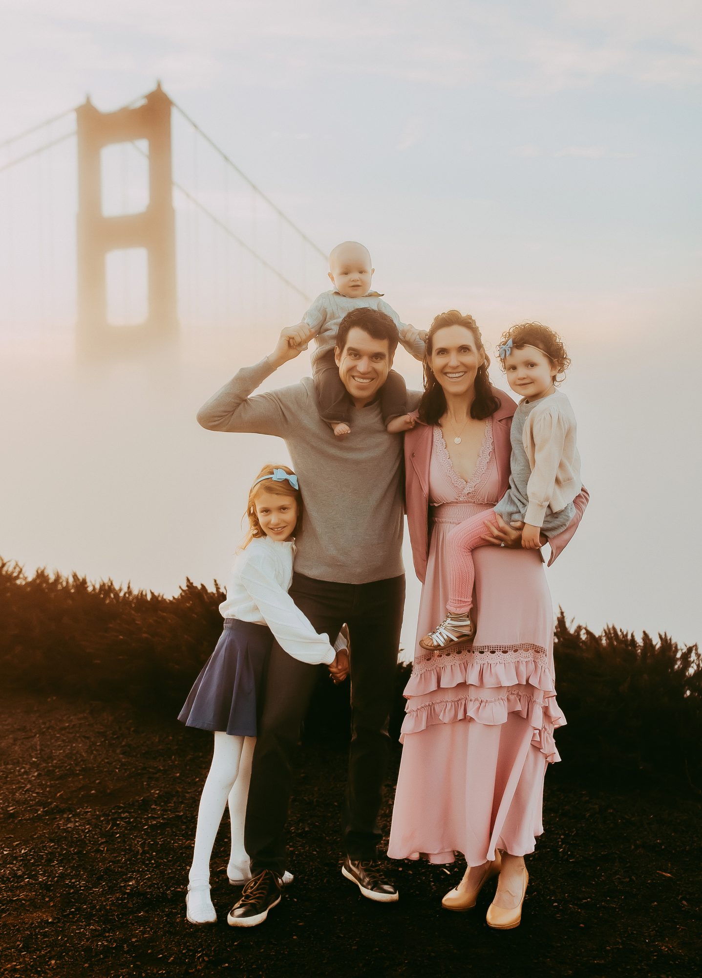 Shefali Parekh | Sunrise Family Photography in Marin County: Capturing Magic in the Morning Family of five posing with Golden gate bridge as background