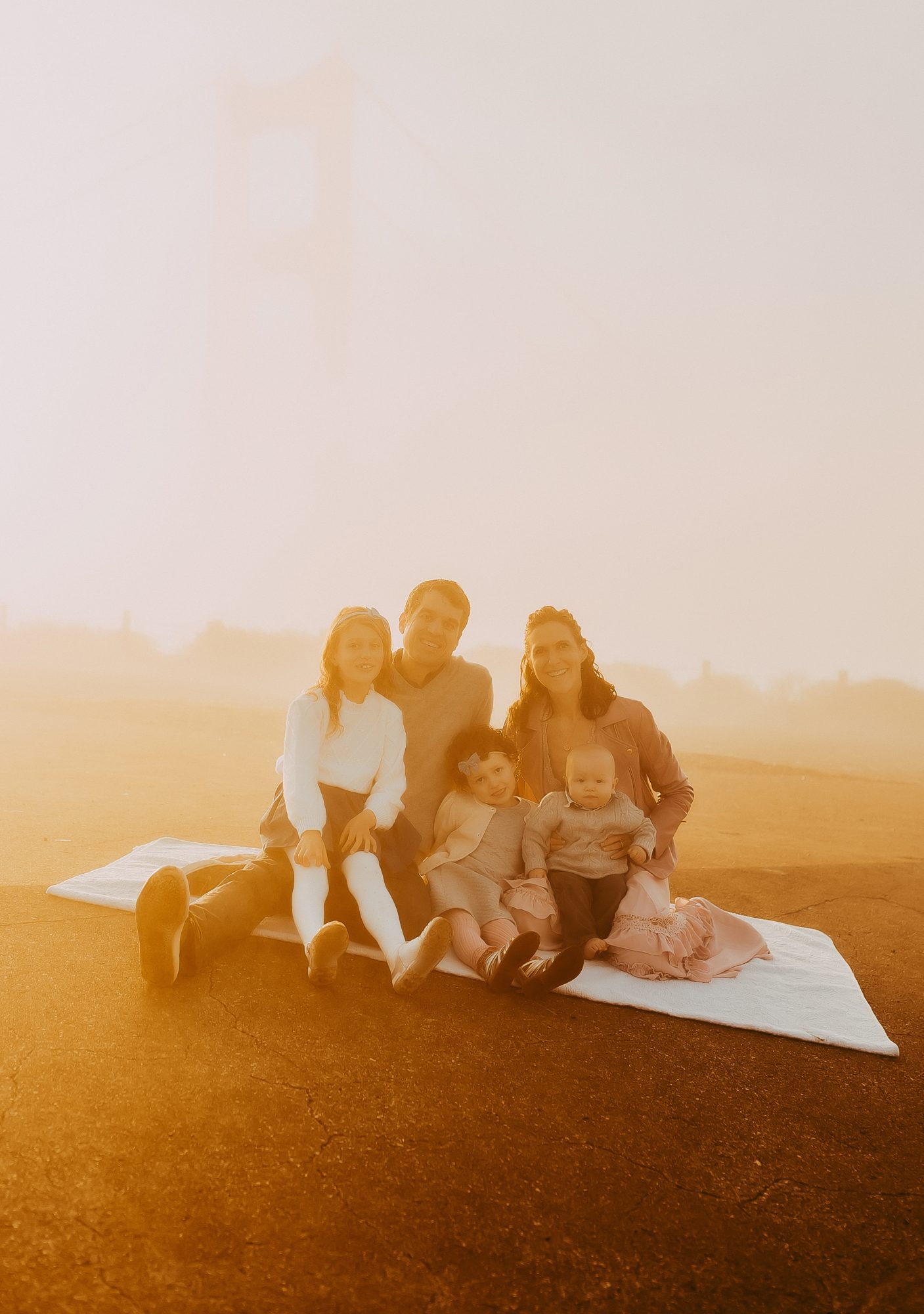 Shefali Parekh | Sunrise Family Photography in Marin County: Capturing Magic in the Morning Family posing sitting together for a picture