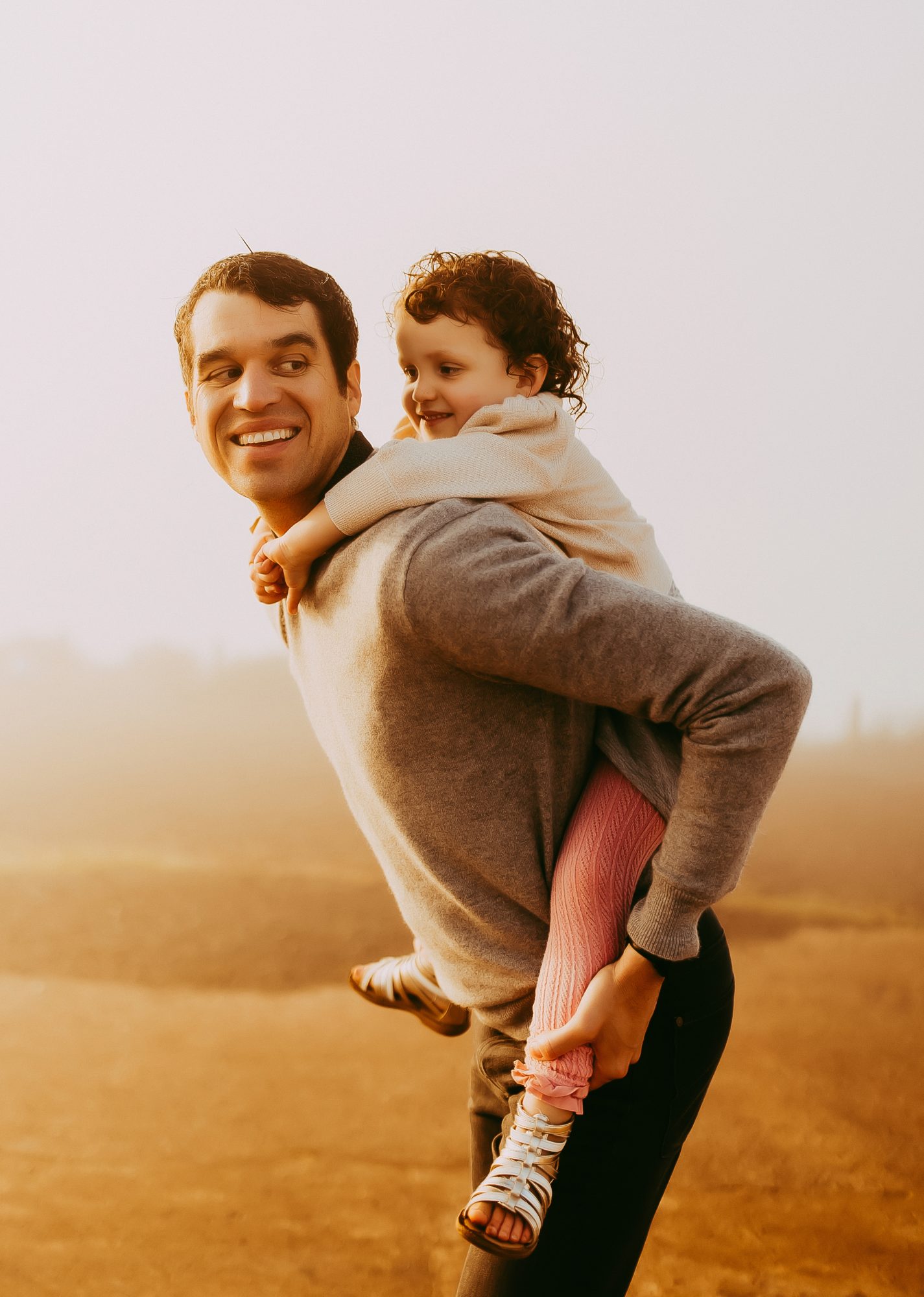 Shefali Parekh | Sunrise Family Photography in Marin County: Capturing Magic in the Morning Father giving piggyback ride to his daughter