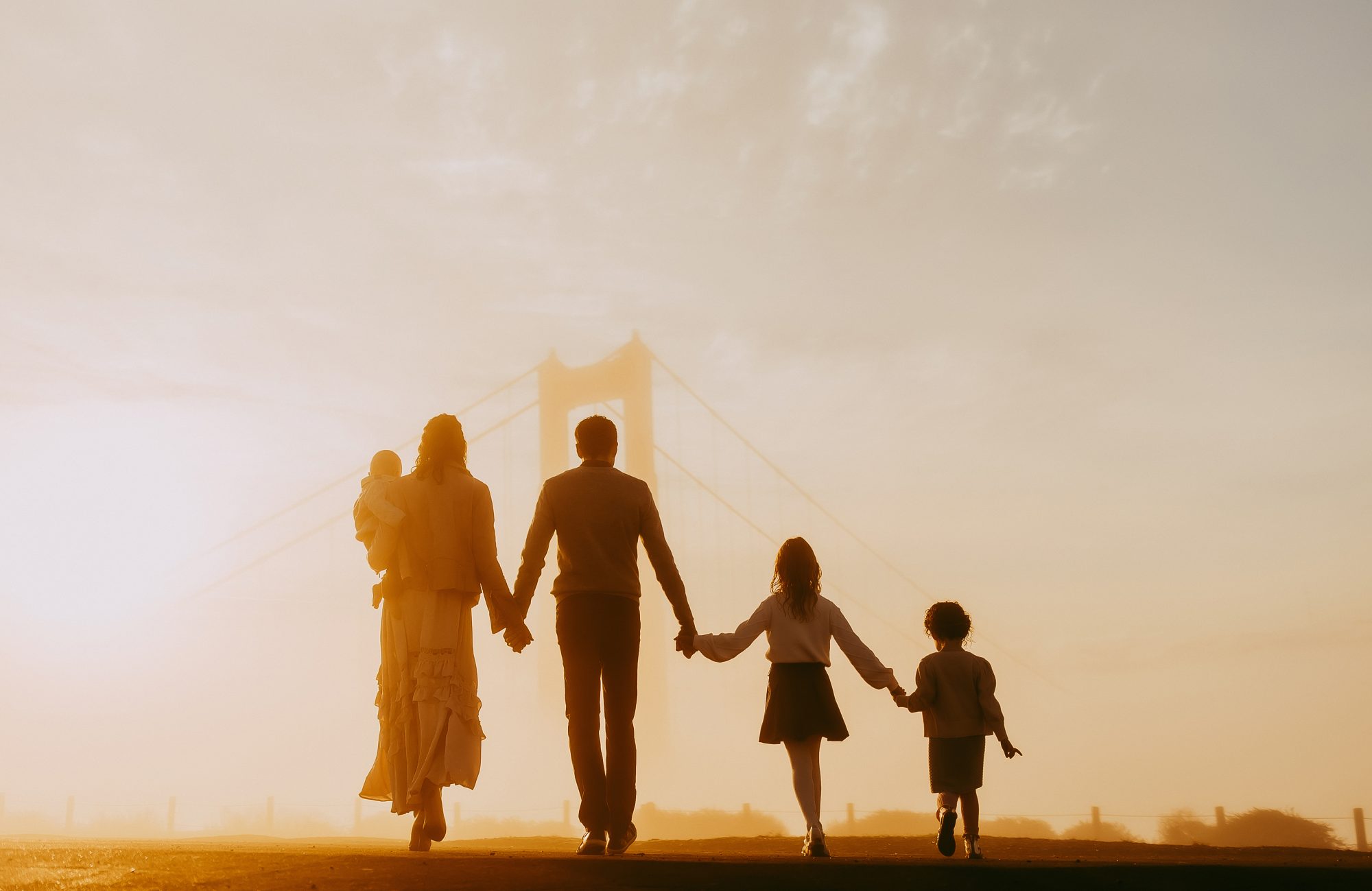 Shefali Parekh | Sunrise Family Photography in Marin County: Capturing Magic in the Morning A family of five posing for a picture showing their backs. Marin County family photographer.