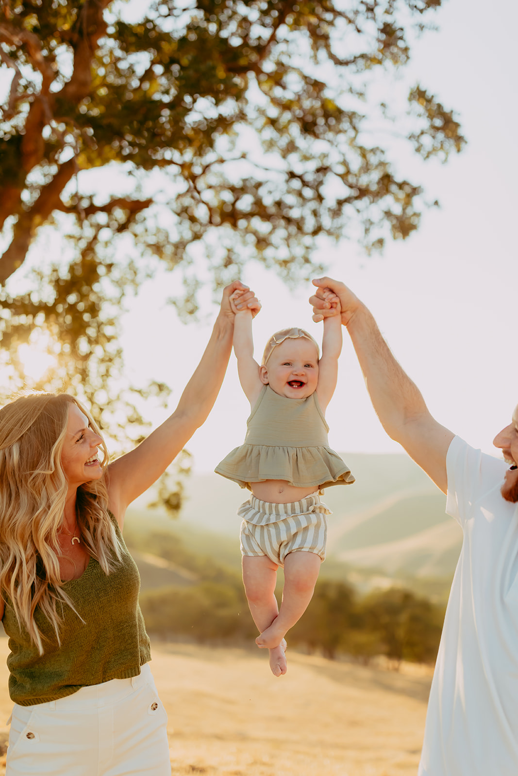 Shefali Parekh | Creating Your Family's Visual Story | Bay Area Photographer Tips Golden hour family portrait of a family of three in a picturesque hillside field