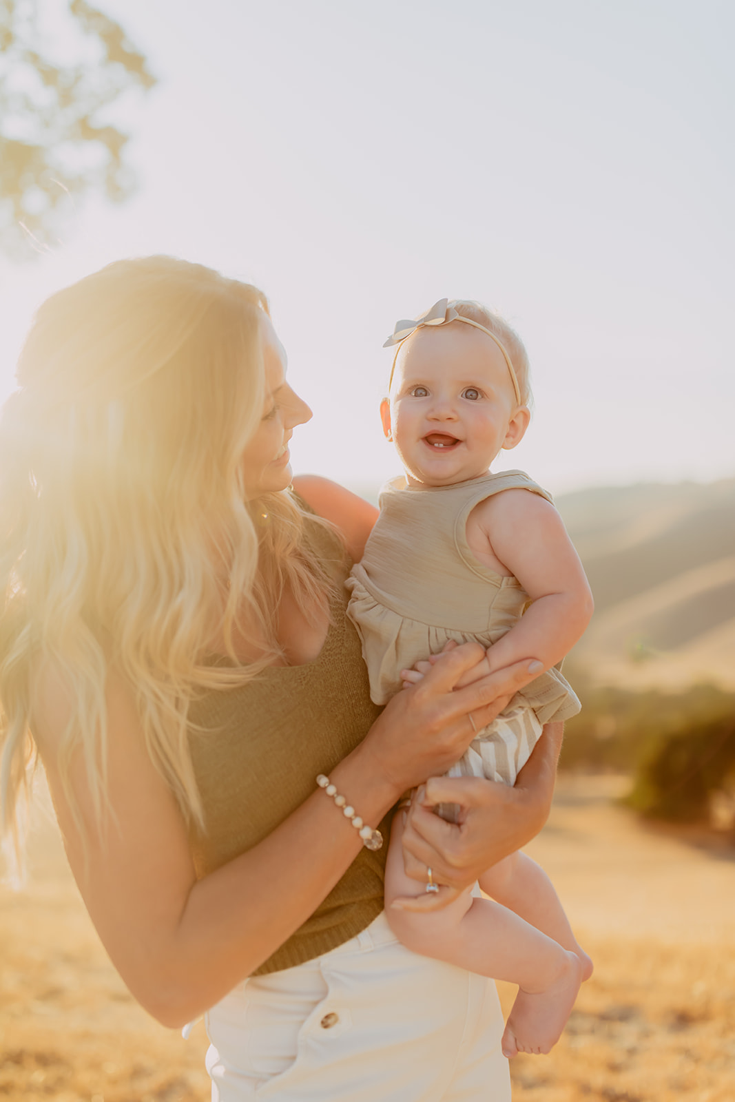 Shefali Parekh | Creating Your Family's Visual Story | Bay Area Photographer Tips Capturing the warmth of golden hour with a mother and her baby girl in a scenic hillside field