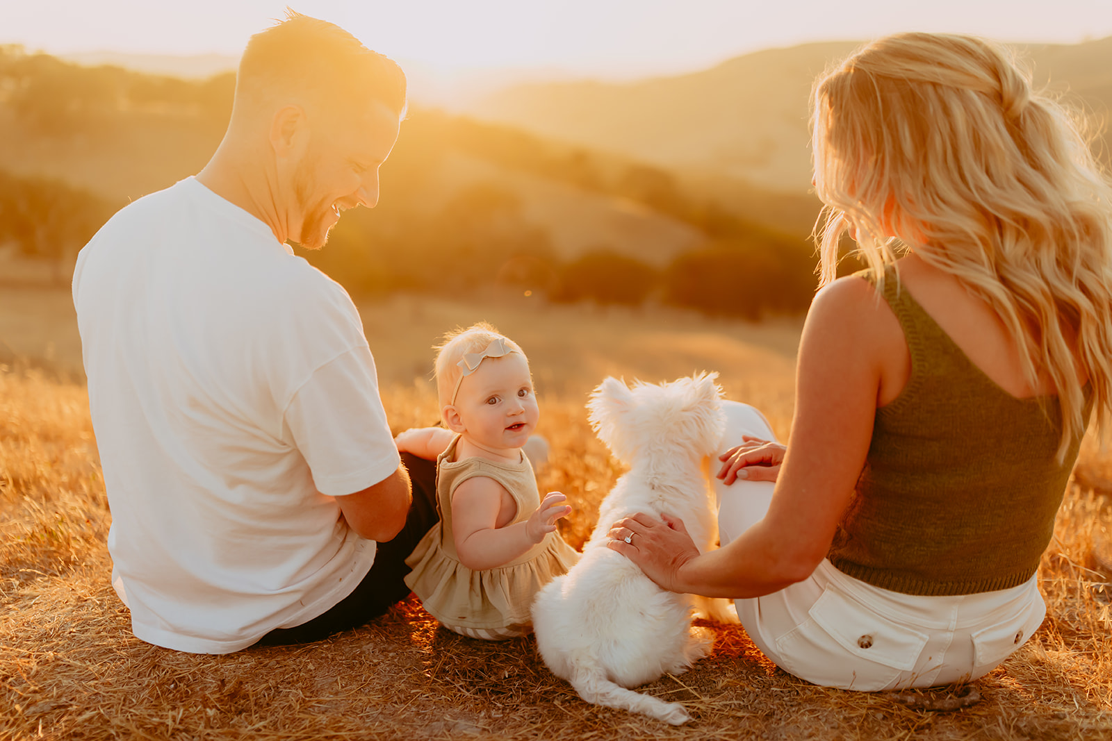 Shefali Parekh | Creating Your Family's Visual Story | Bay Area Photographer Tips Family photos capturing a family of three enjoying a sunset in a scenic field overlooking hills
