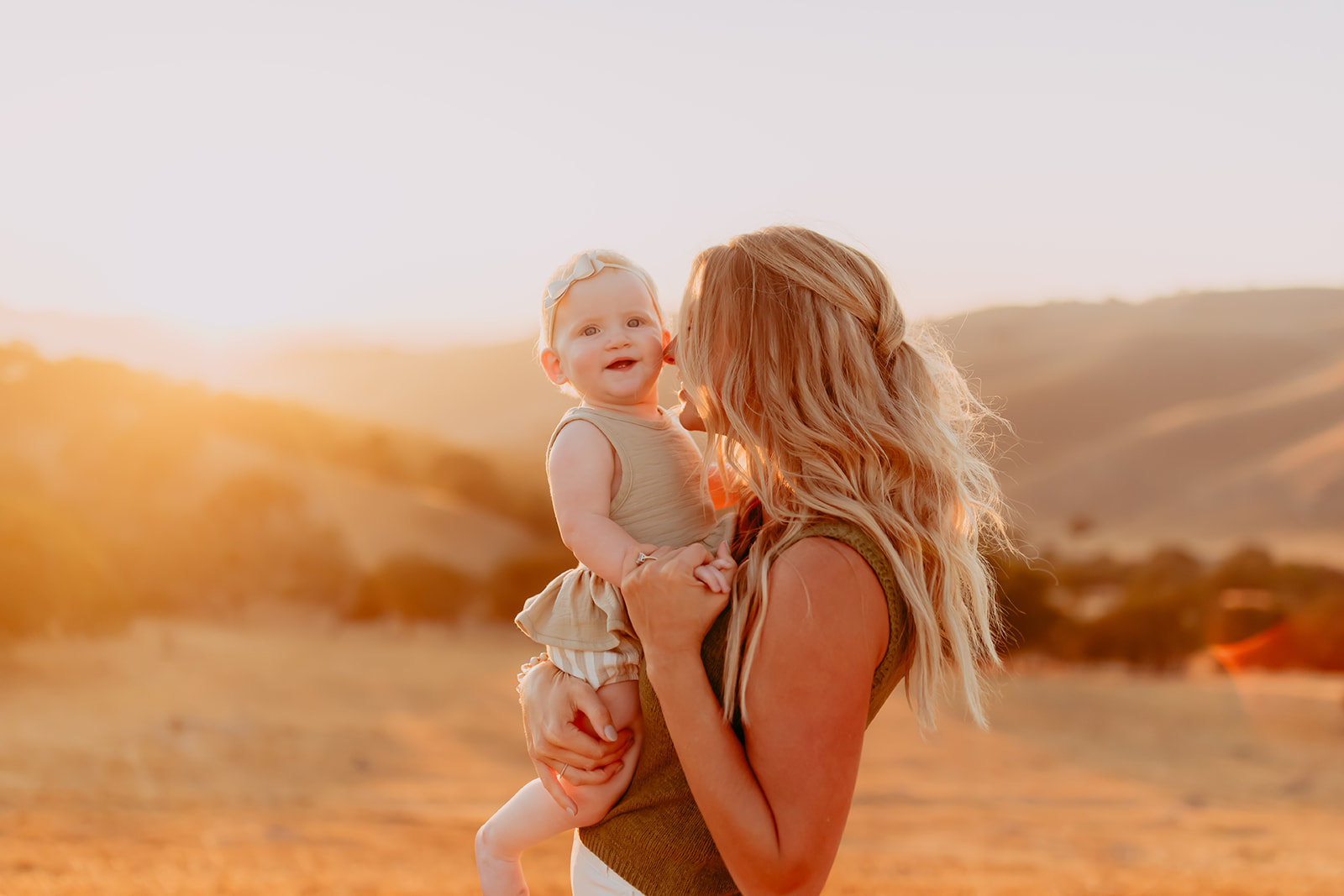 Shefali Parekh | Creating Your Family's Visual Story | Bay Area Photographer Tips Intimate family photo of a mother and her baby girl during golden hour in a picturesque hillside field