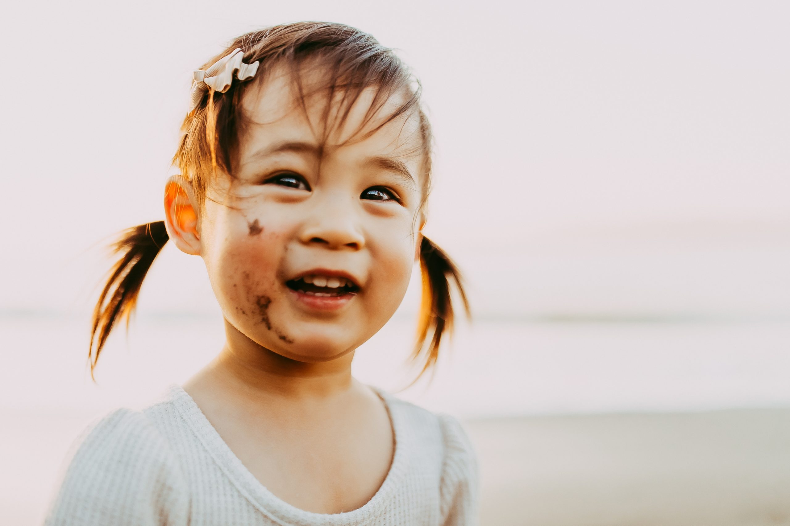 Shefali Parekh | Bay Area Beach Family Photoshoot Tips kid playing with sand at the beach in san francisco
