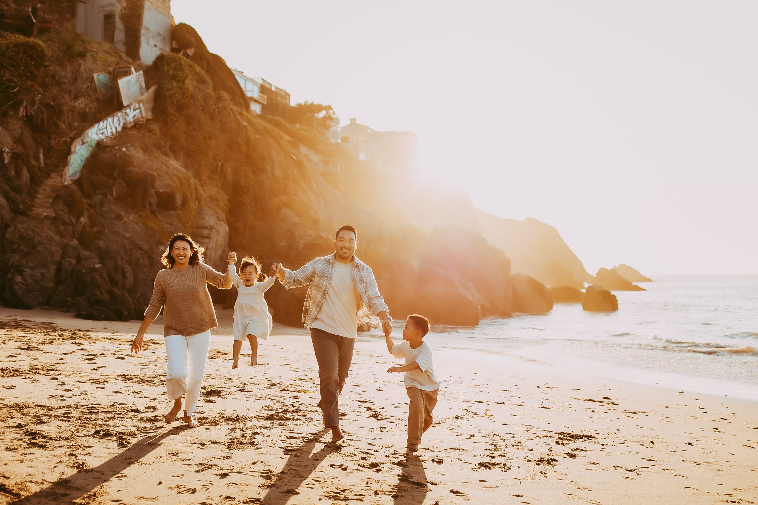 Shefali Parekh | Bay Area Beach Family Photoshoot Tips Golden hour glow over a family during their Bay Area beach session.