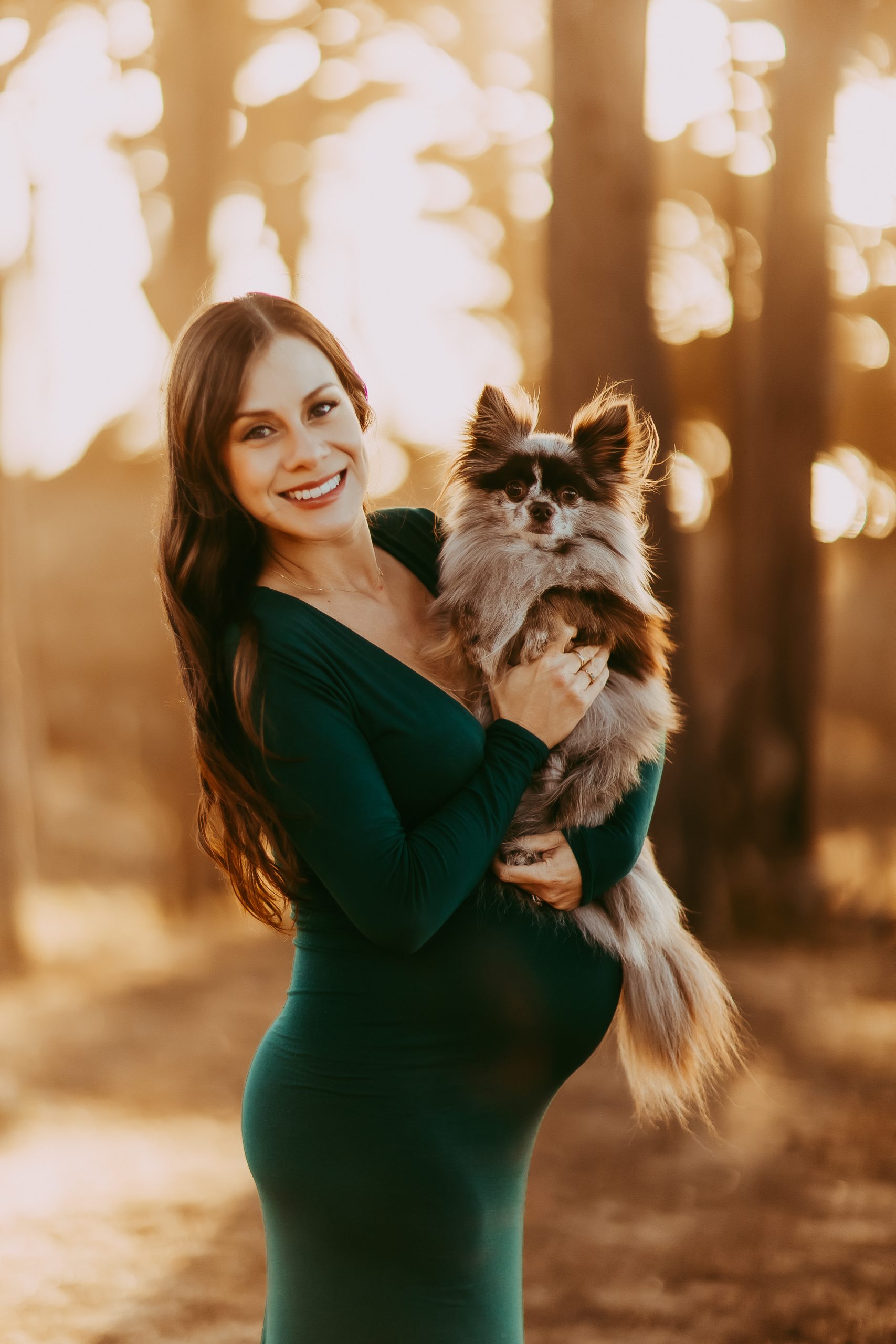 Expecting mother cuddling her dog in a cozy maternity photoshoot