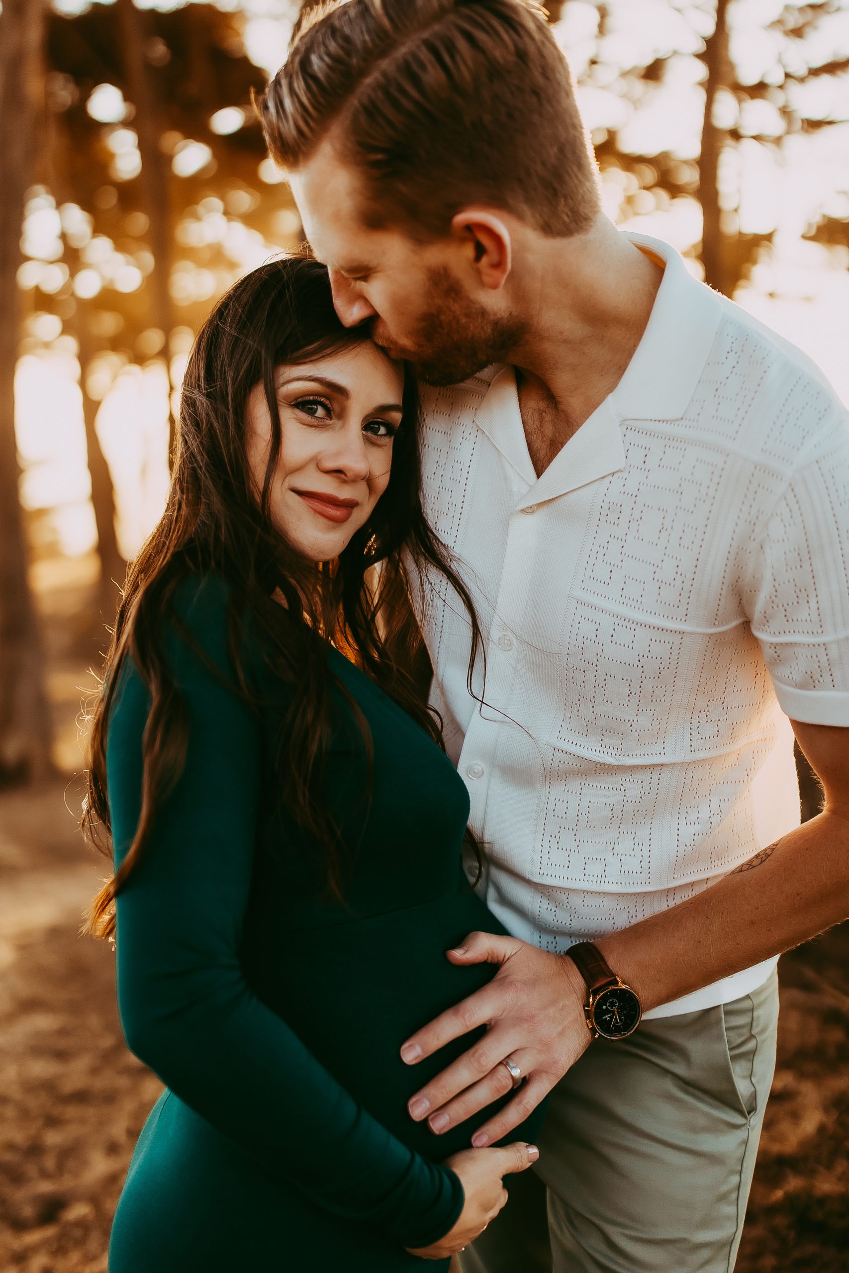 Husband holding his wife’s baby bump with joy and anticipation