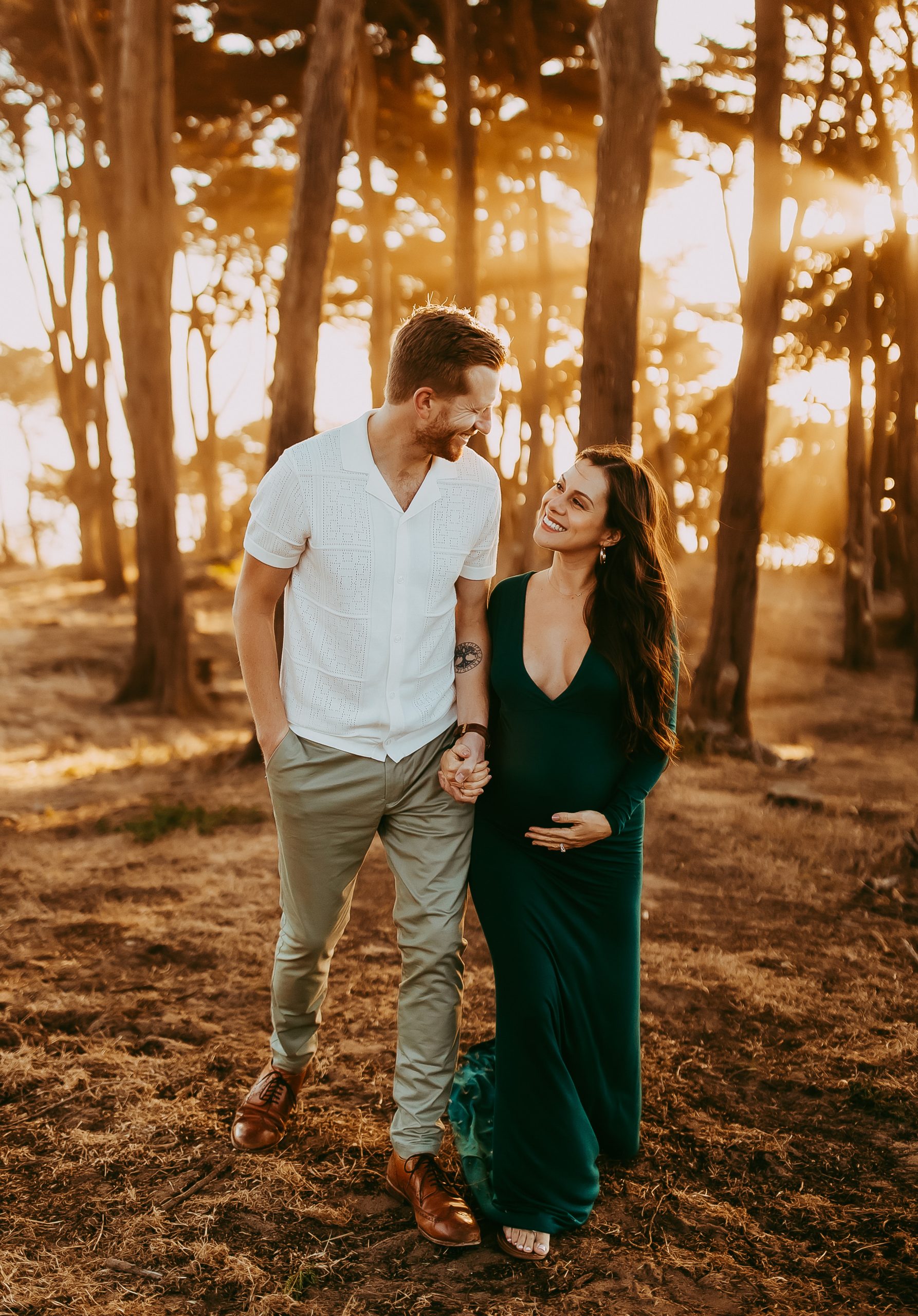 Laughing parents-to-be during an outdoor maternity shoot in the Bay Area