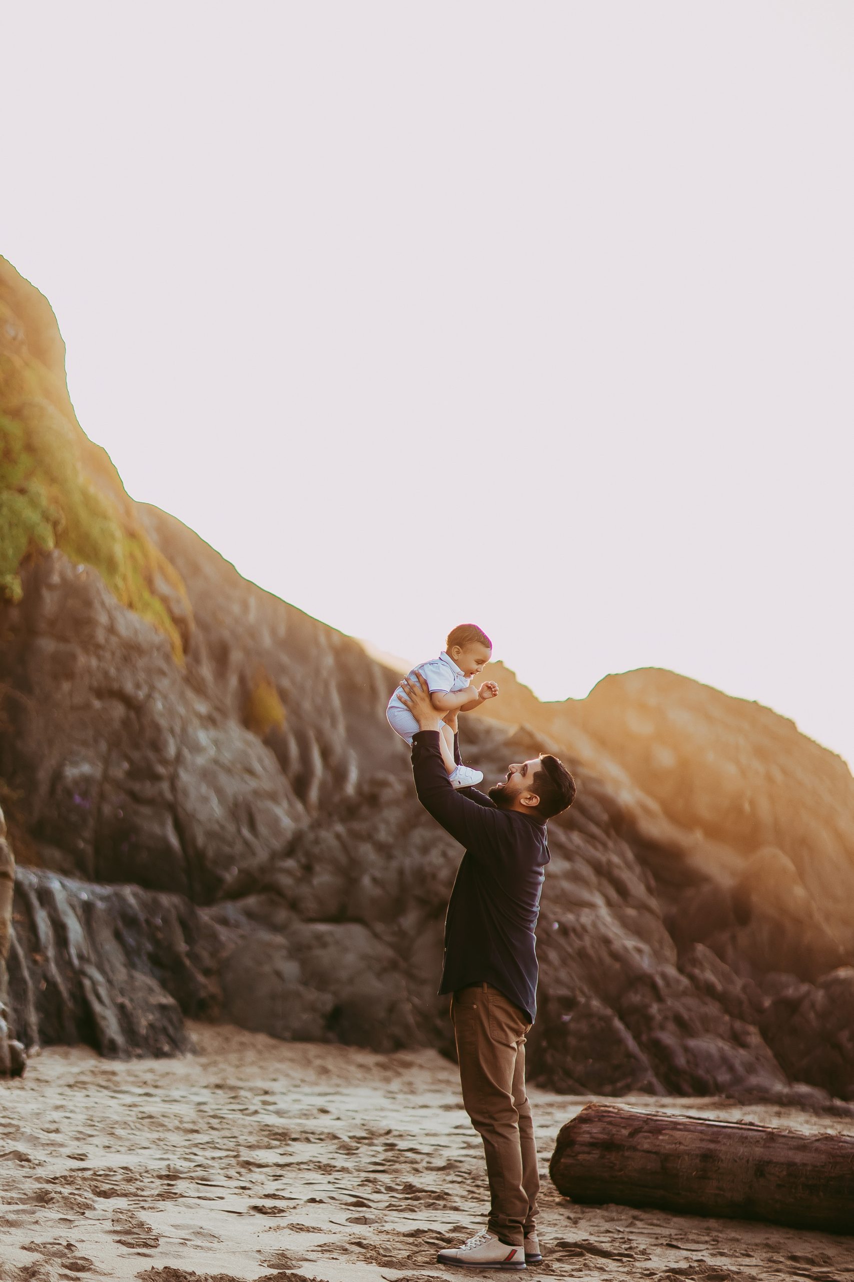 Shefali Parekh | The Best Time for a Baker Beach Photoshoot dad tossing son up in the air at the beach