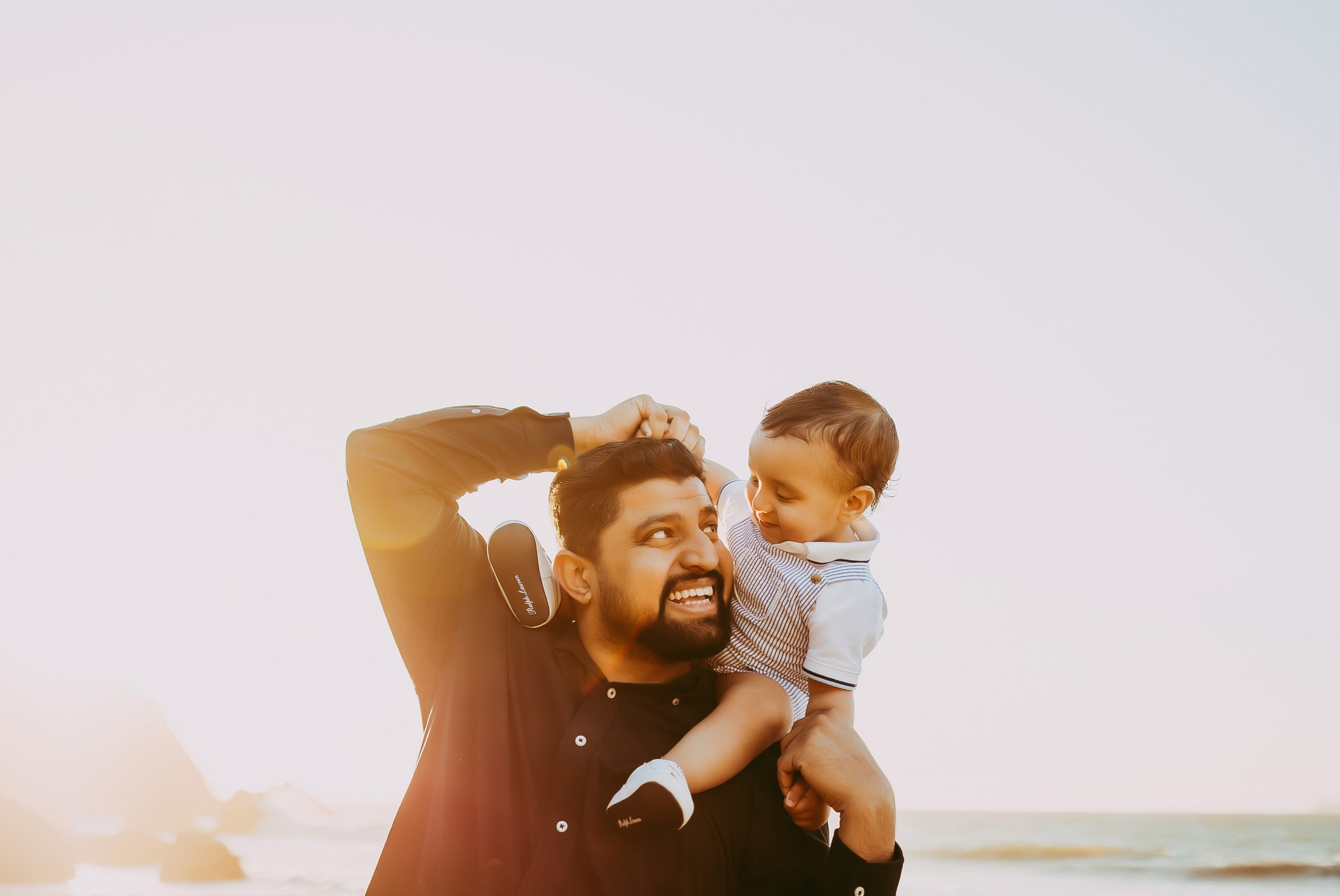 Shefali Parekh | The Best Time for a Baker Beach Photoshoot dad and son laughing at beach in san francisco