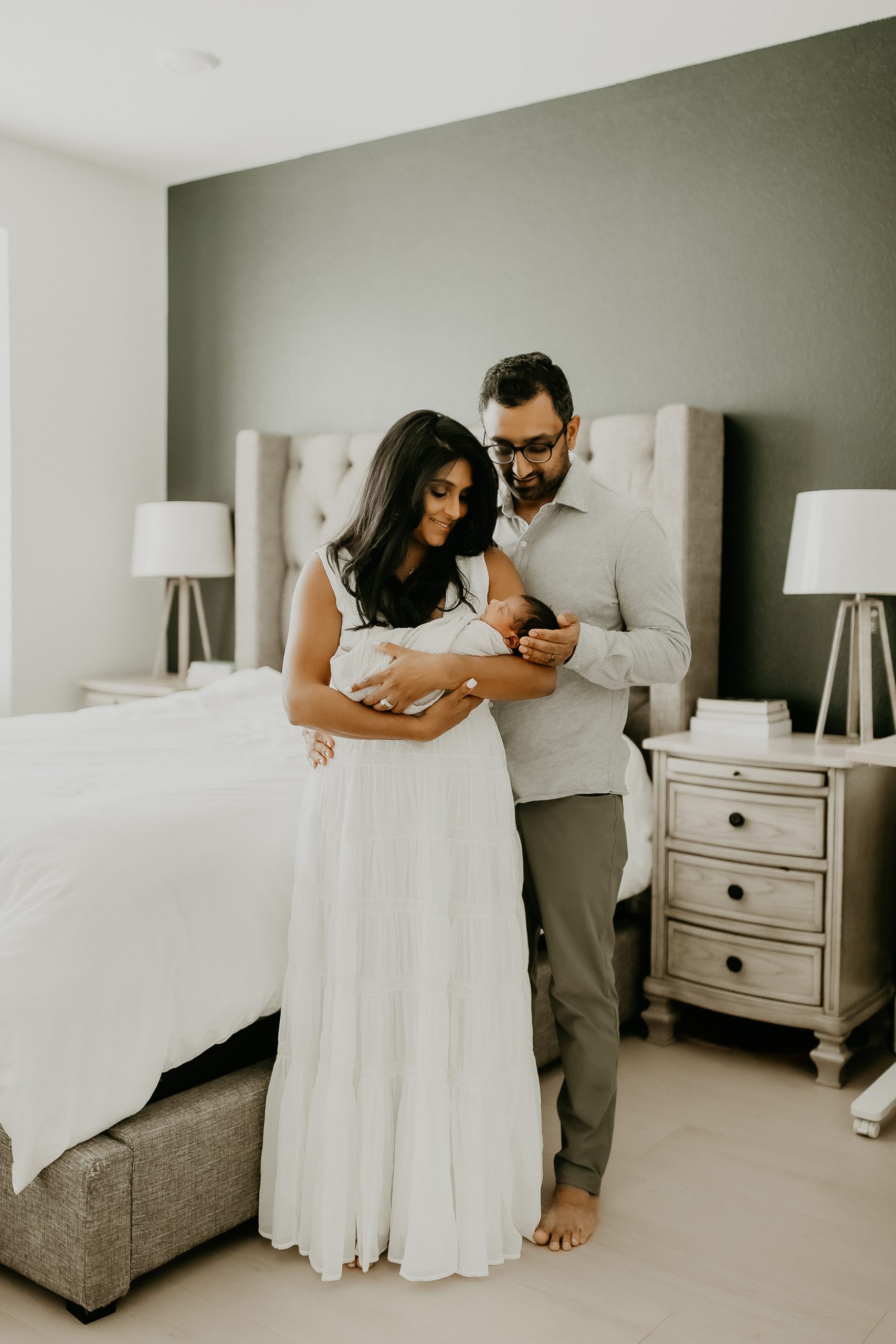 Shefali Parekh | Newborn Photography Trends in San Francisco: What's Popular in 2025 New parents holding their newborn baby, captured in a lifestyle newborn photography session in San Francisco