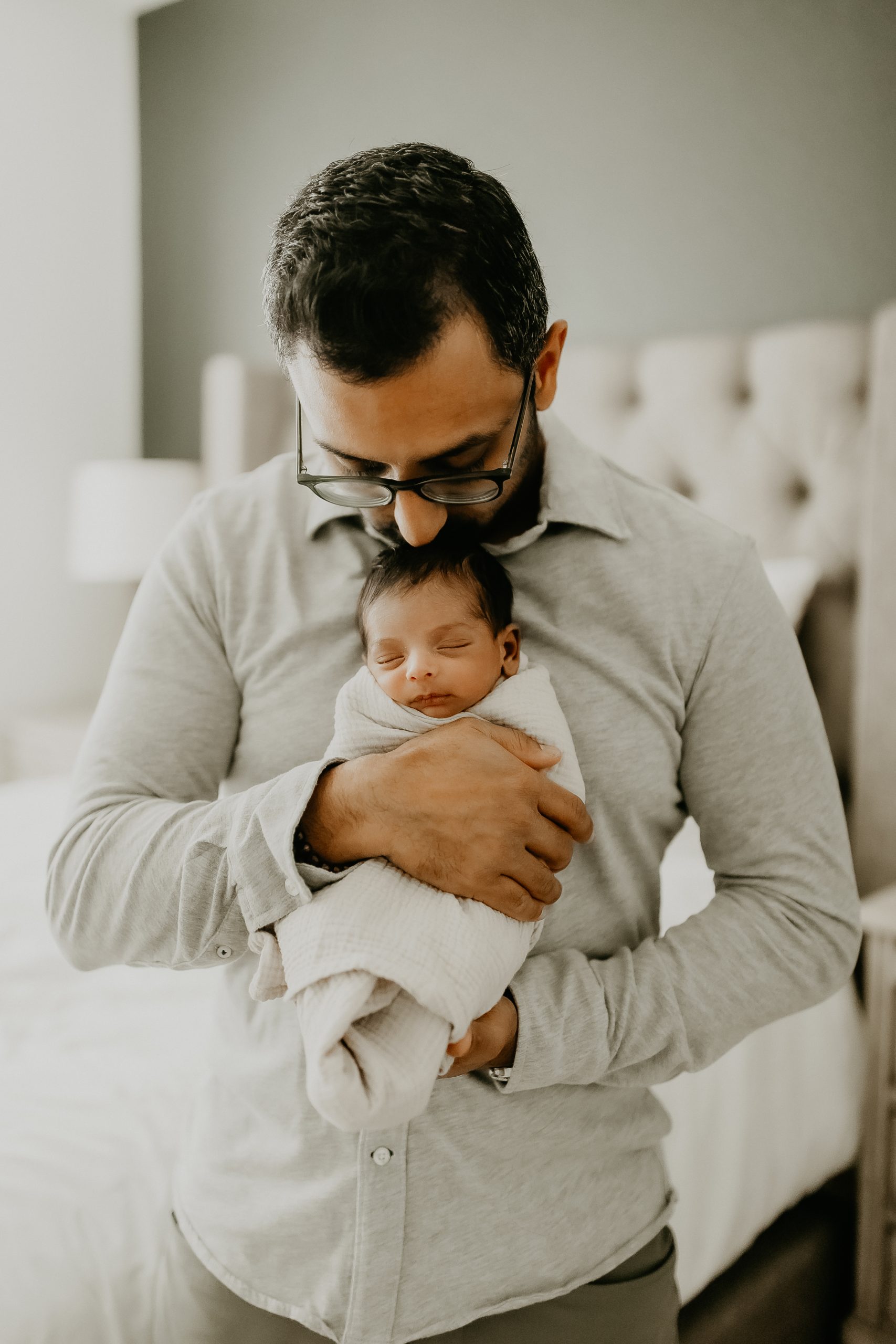 Shefali Parekh | Newborn Photography Trends in San Francisco: What's Popular in 2025 Father holding his newborn baby close during a lifestyle newborn photography session in San Francisco