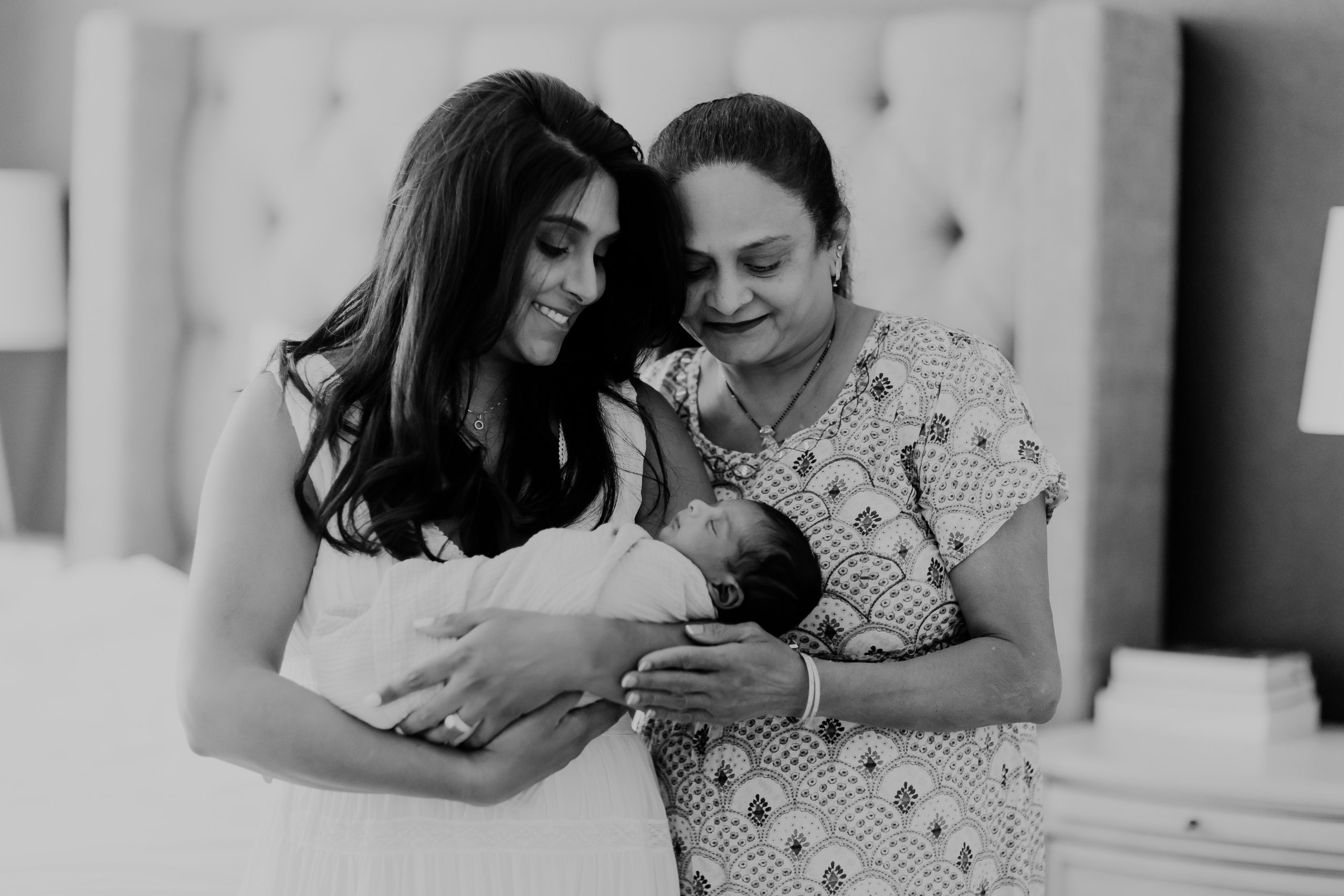 Shefali Parekh | Newborn Photography Trends in San Francisco: What's Popular in 2025 Candid moment of a newborn baby bonding with their grandma, captured in a San Francisco home photography session.