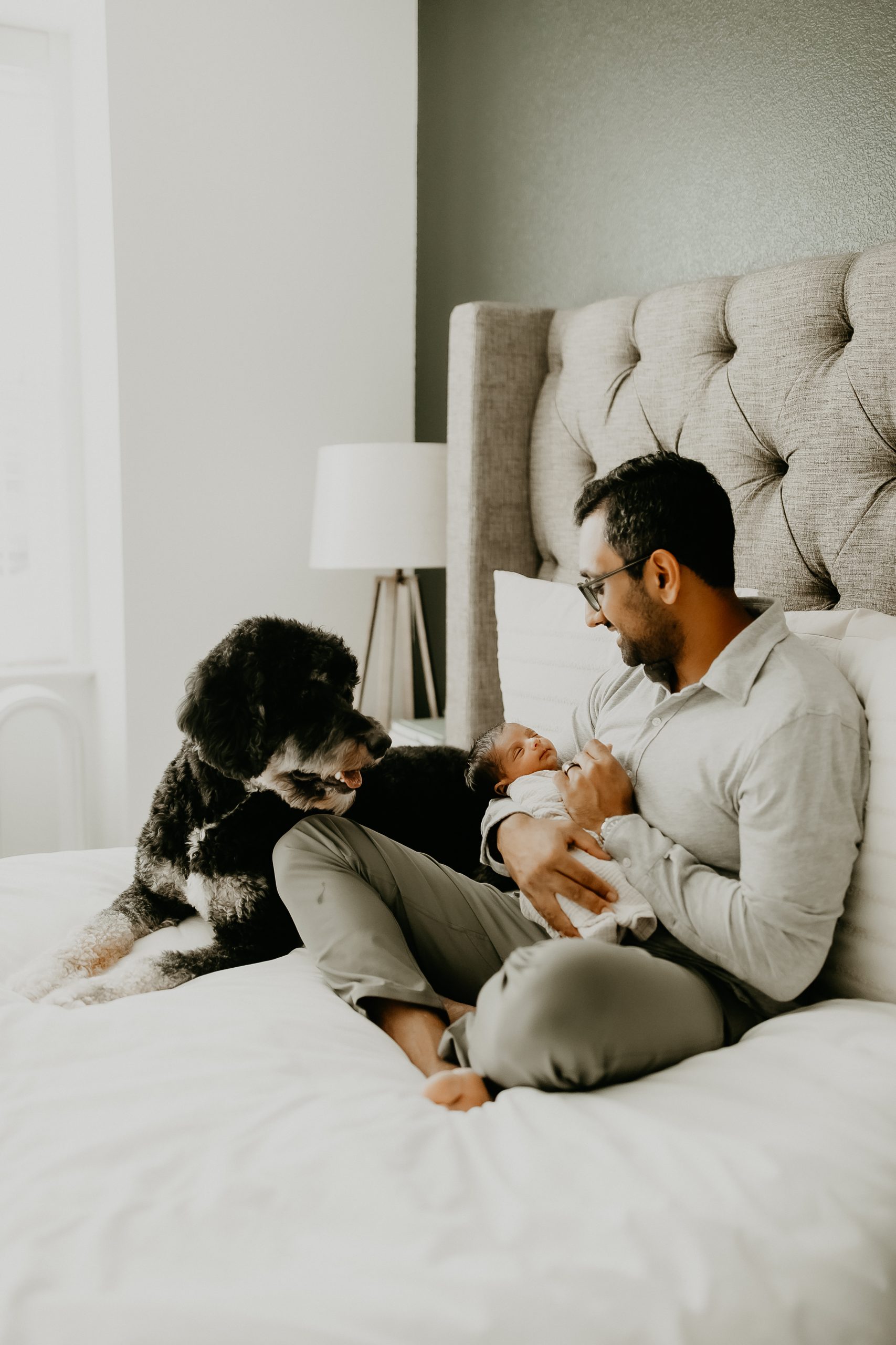 Shefali Parekh | Newborn Photography Trends in San Francisco: What's Popular in 2025 Baby and dog cuddled together, a heartwarming moment from a lifestyle newborn photography session in San Francisco