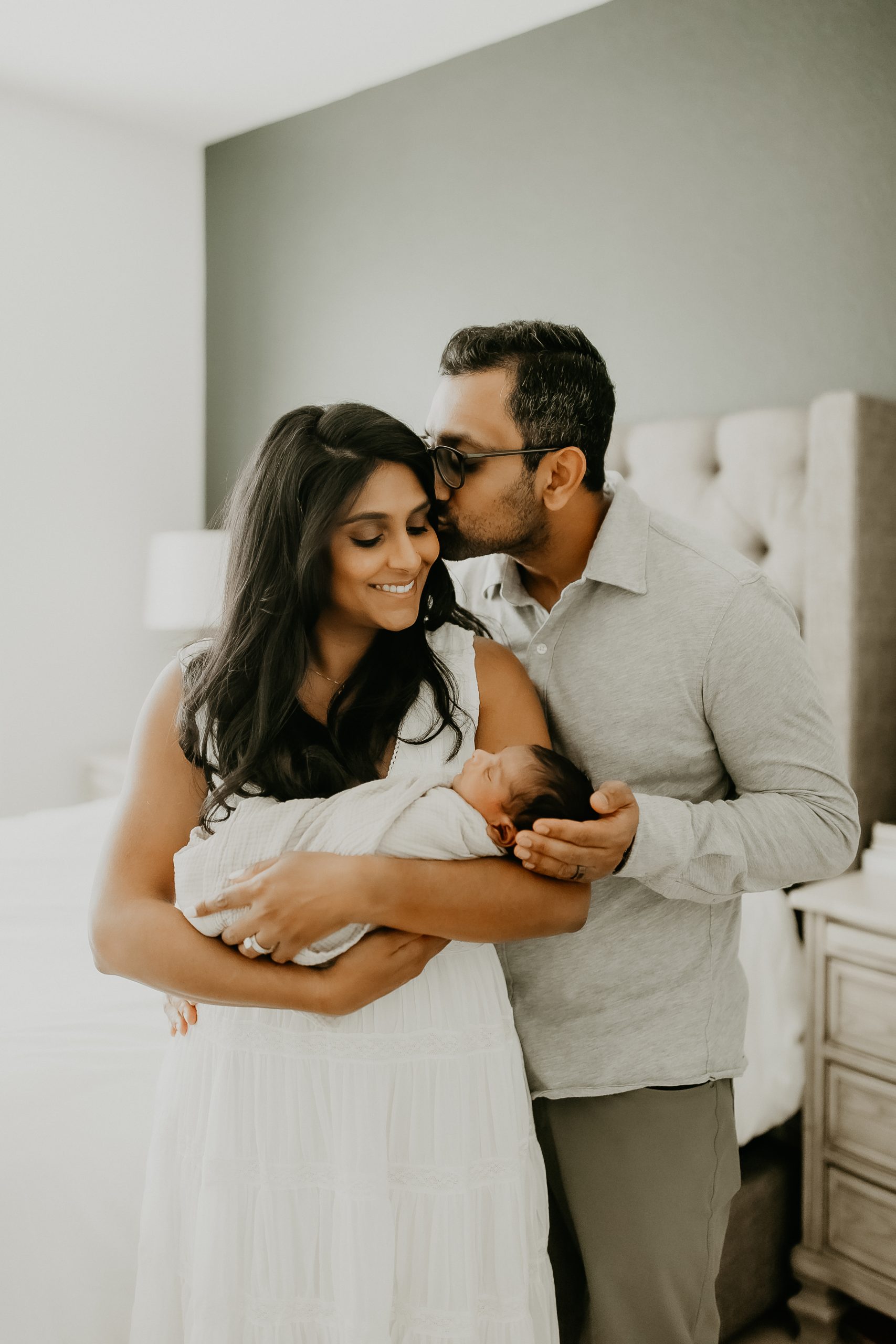 Shefali Parekh | Newborn Photography Trends in San Francisco: What's Popular in 2025 Candid moment of parents bonding with their newborn baby during an in-home photography session in San Francisco