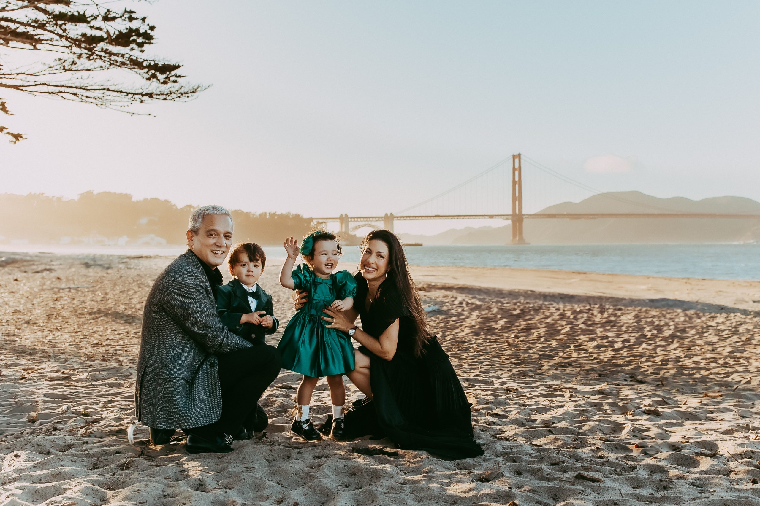 Shefali Parekh | Why Booking a Photoshoot in San Francisco, CA Should Be on Your Vacation Bucket List Family sitting on beach in San Francisco, CA