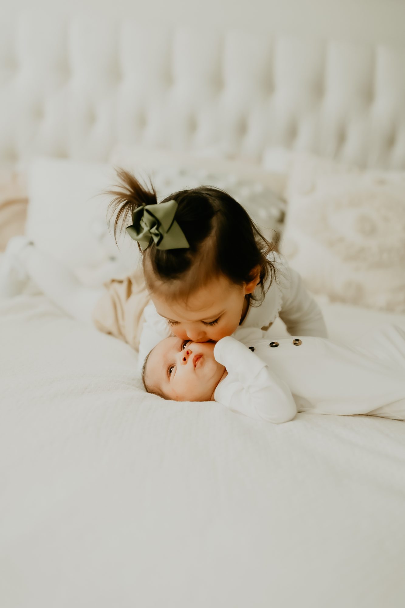 Shefali Parekh | TESTIMONIALS Big sibling planting a gentle kiss on baby’s head, full of sibling love