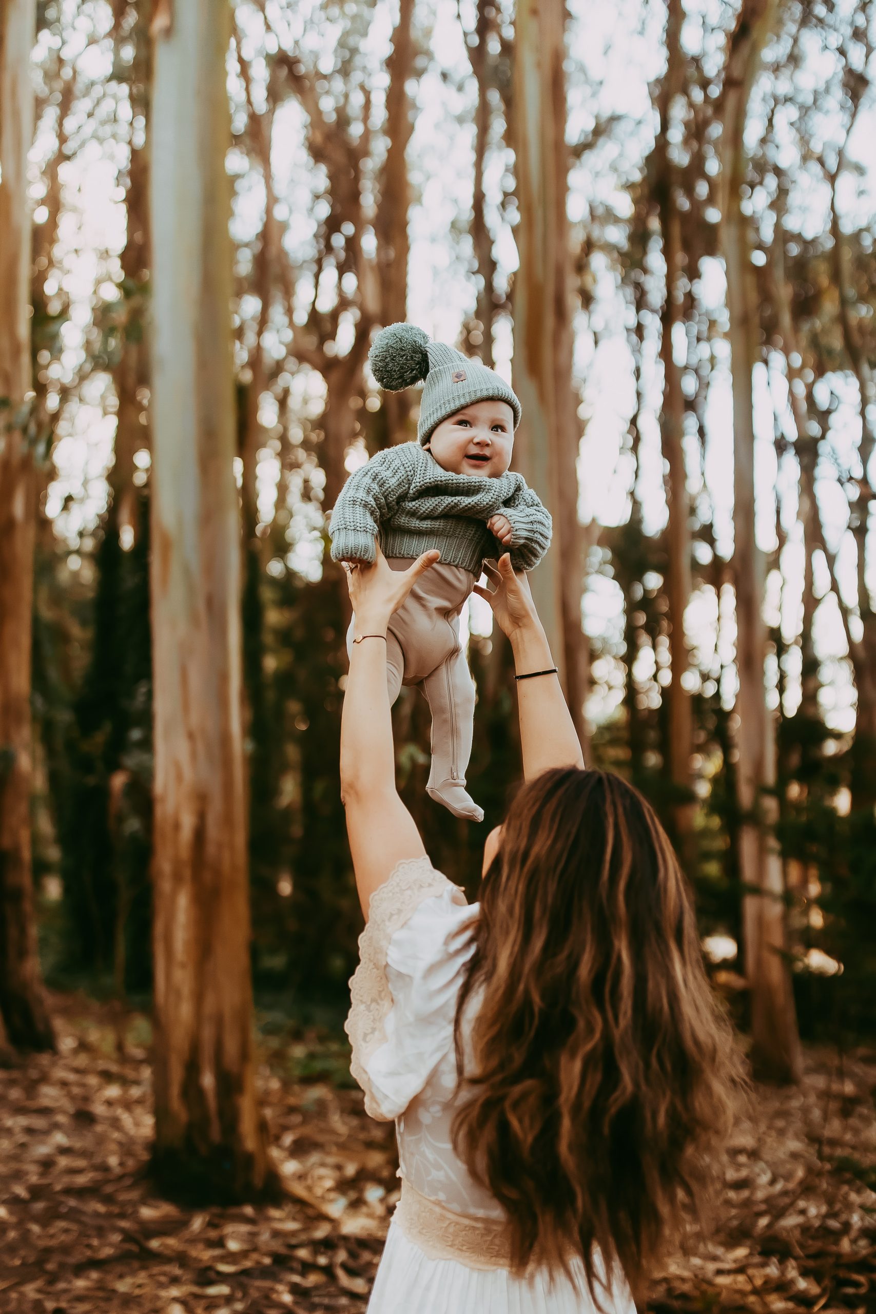Shefali Parekh | Lovers Lane, San Francisco Family Photography Session Mother lifting baby boy in the air during a joyful family session at Lovers Lane