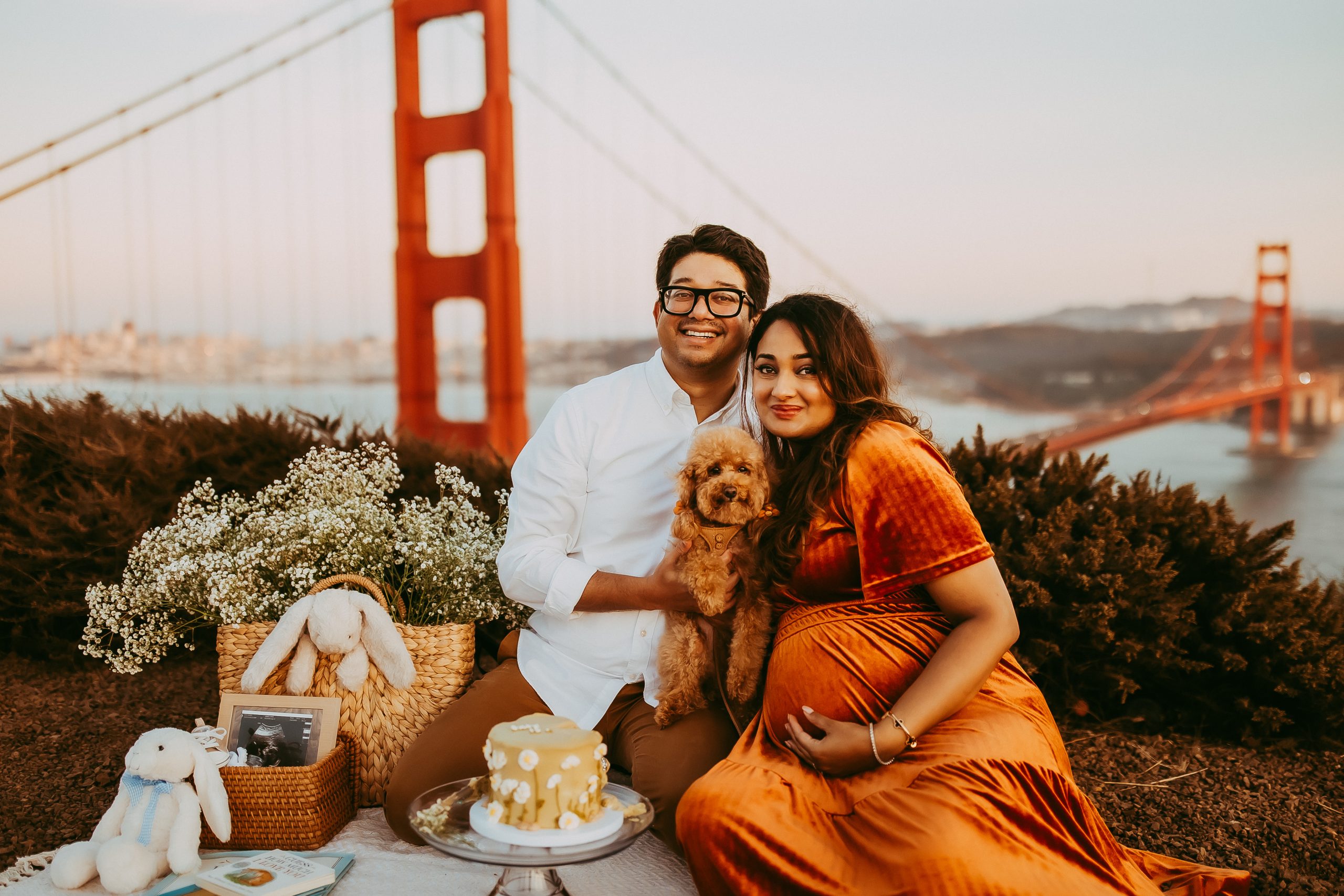 Shefali Parekh | Picnic Gender Reveal | Marin County Maternity Photographer Expecting couple sitting on picnic blanket with Golden Gate Bridge views, Marin County maternity photography session